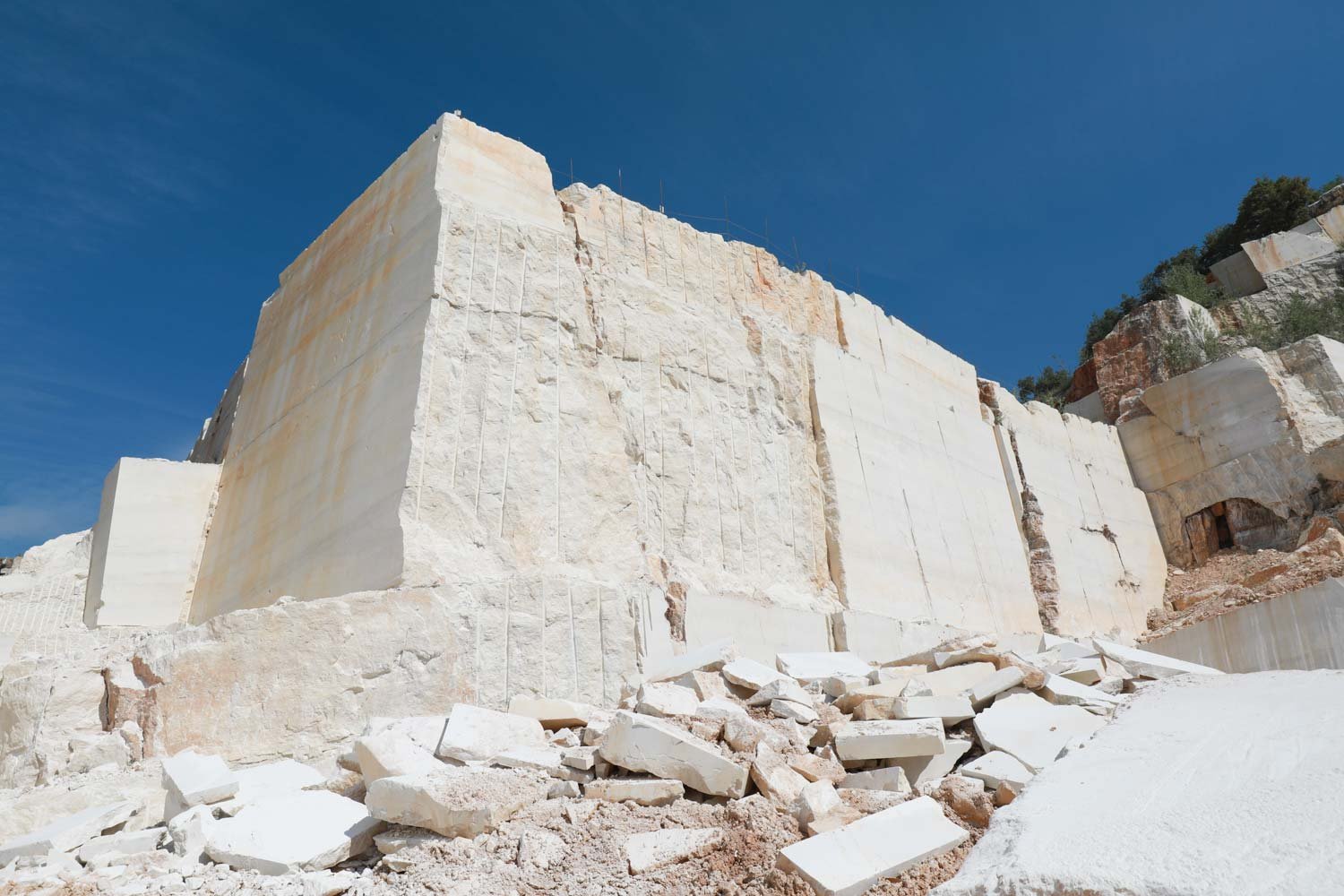 Italian marble quarry face and extracted stone blocks before slab selection